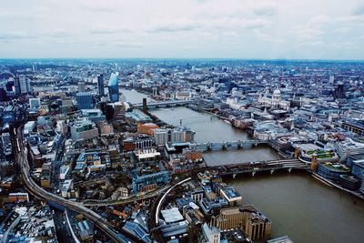 High angle view of buildings by sea against sky