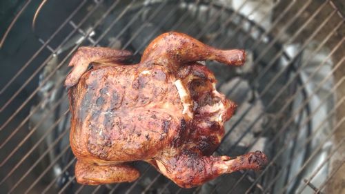 High angle view of meat on barbecue grill