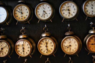 Old damaged alarm clocks hanging on wall