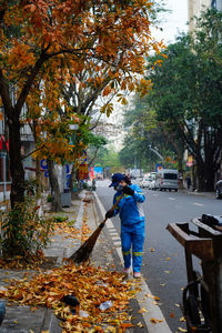 Rear view of man working at park