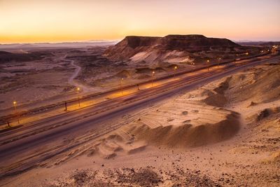 Scenic view of desert against sky during sunset