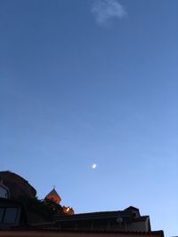 Low angle view of buildings against blue sky