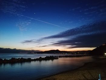 Scenic view of lake against sky at sunset