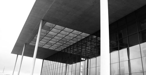 Low angle view of glass building against sky