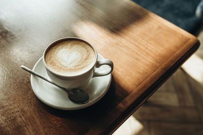 Cup of latte on the table top view. breakfast at the cafe