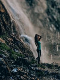 Side view of man standing on rock