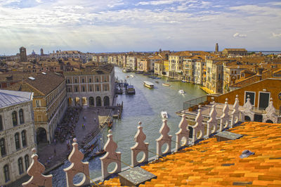 High angle view of buildings by sea against sky