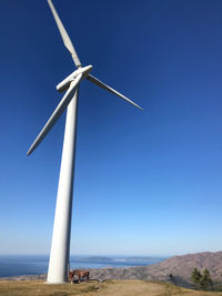 Low angle view of wind turbine against clear sky