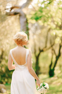 Rear view of woman standing against sky