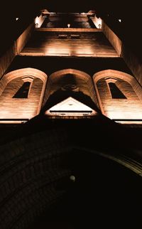 Low angle view of illuminated lighting equipment at night