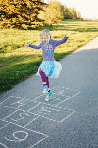 Full length of cute girl playing outdoors