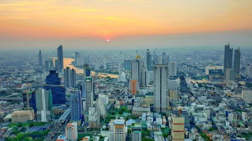 High angle view of city buildings during sunset