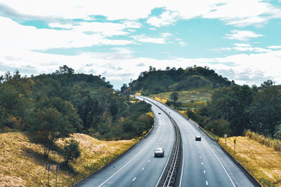 Road passing through mountain against sky