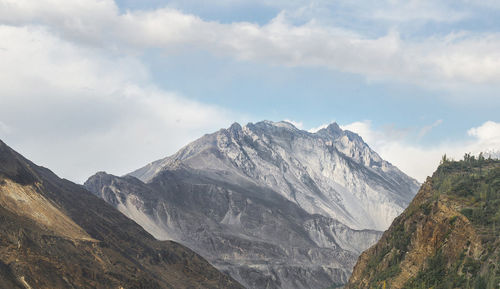 Scenic view of mountains against cloudy sky