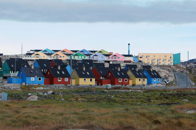 Houses on field against sky