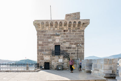 Rear view of woman standing against sky