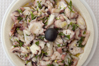 Directly above shot of calamari served in bowl on table