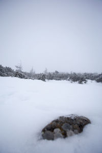 Frozen landscape against clear sky
