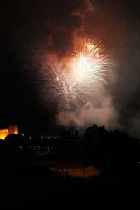 Low angle view of fireworks against sky at night