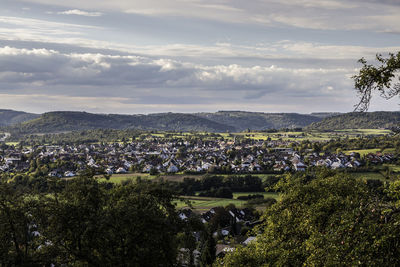 Aerial view of trees and buildings against sky