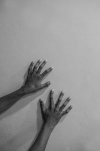 Close-up of hand touching wall