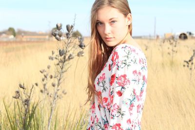 Portrait of young woman in field