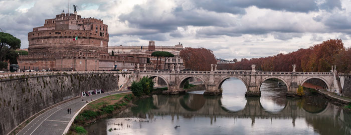 Arch bridge against cloudy sky