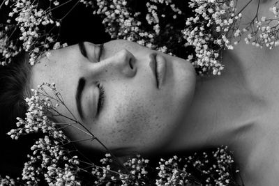 High angle view of woman lying down amidst plants