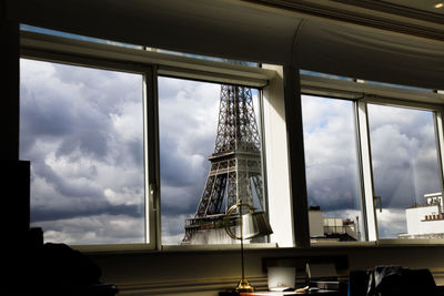 Low angle view of skyscraper against cloudy sky