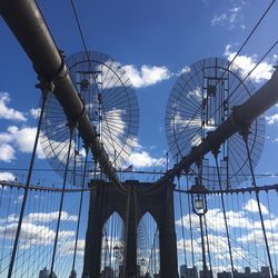 Low angle view of bridge against cloudy sky