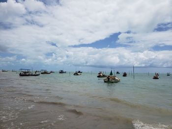 Boats in sea against sky