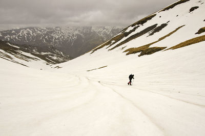 Full length of person on snowcapped mountain