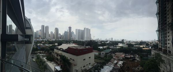 Cityscape against cloudy sky