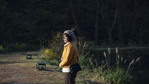 Rear view of woman walking on field