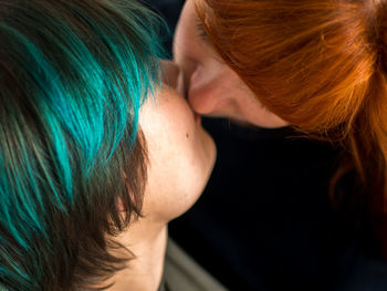 Close-up of lesbian couple kissing at home