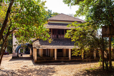 Exterior of building by trees against sky