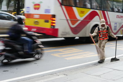 Blurred motion of people walking on road