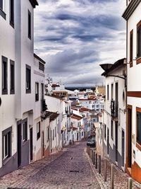 Buildings against cloudy sky