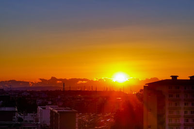 High angle view of buildings against sky during sunset