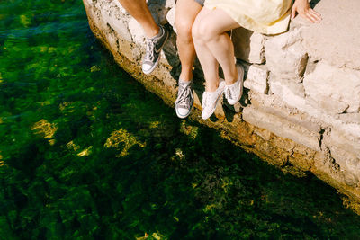 Low section of person standing on shore