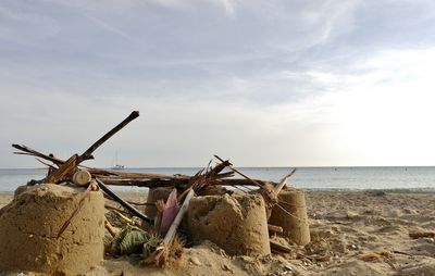 Abandoned built structure on beach against sky