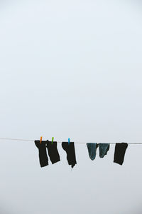 Low angle view of clothes drying on clothesline against sky