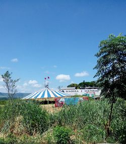 View of ferris wheel against blue sky