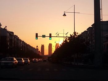 Traffic on road at sunset