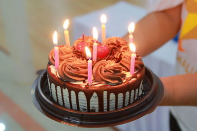 Close-up of cake on burning candles