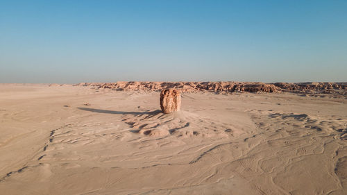 Sand dune in desert against clear sky