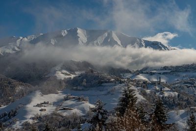 Scenic view of snowcapped mountains against sky