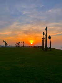 Scenic view of field against sky during sunset