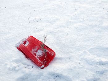 High angle view of red telephone on snow