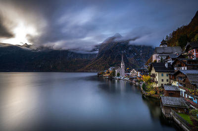 Scenic view of lake by buildings against sky